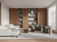 a living room filled with white furniture and wooden bookshelves next to a window