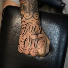 a person's foot with the words trust no one tattooed on it, sitting in a chair