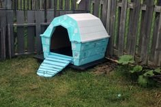 a dog house that is in the grass