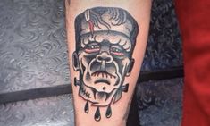 a man's leg with a tattoo on it that has an image of a demon