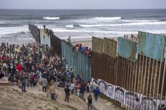 a crowd of people standing next to the ocean