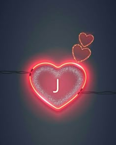 a heart shaped neon sign with the letter j hanging from it's side on a string