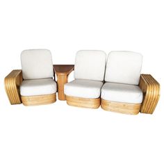 two chairs and a table with white cushions