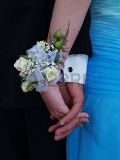 the bride and groom are holding hands with their wedding bouquets in each hand,