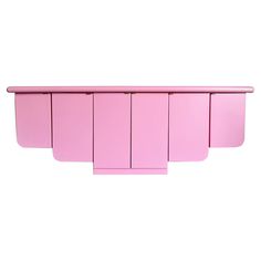 a pink shelf with five sections on each side and one section above the other, in front of a white background