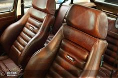 two brown leather seats in the front and back of a car