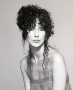 a black and white photo of a woman with curly hair