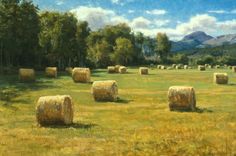 a painting of hay bales in an open field with mountains in the back ground