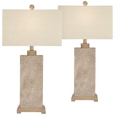 a pair of table lamps sitting next to each other on top of a white floor