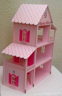 a pink doll house sitting on top of a table