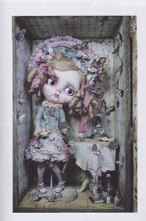 a doll in a wooden box with butterflies around it