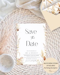 save the date card on top of a wicker basket with white and gold accents