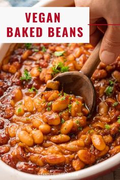 vegan baked beans in a white bowl with a wooden spoon