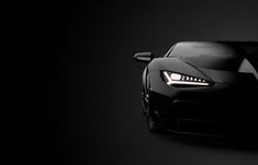 a black sports car is shown in the dark