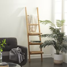 a living room filled with furniture and a tall wooden ladder next to a potted plant