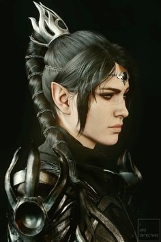 a woman with black hair and metal armor