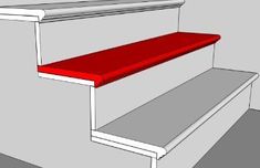 a red bench sitting on top of a set of stairs next to a white wall