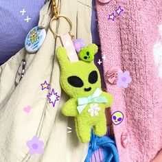 a stuffed animal keychain hanging from the back of someone's purse,