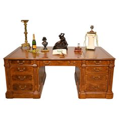 a wooden desk topped with lots of books and figurines on top of it