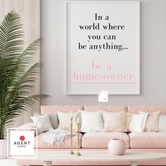 a living room with pink couches, pillows and a large poster on the wall