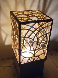 a lamp that is on top of a wooden floor next to a wall and window