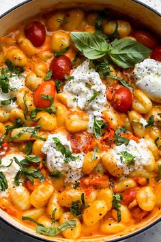 a pot filled with pasta and cheese on top of a table