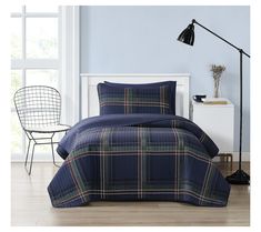 a blue plaid comforter set in a bedroom