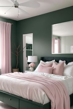 a bedroom with green walls and white bedding, pink pillows on the headboard