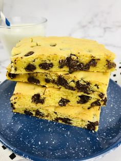 two chocolate chip cookie bars stacked on top of each other next to a glass of milk