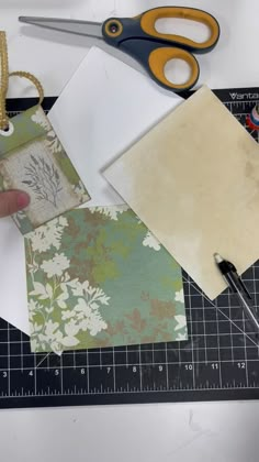 scissors, paper and other crafting supplies on a table