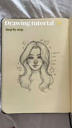 an open book with a drawing of a woman's face on the cover and text that reads, drawing tutor step by step