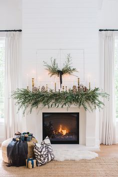 a living room with a fire place and christmas decorations