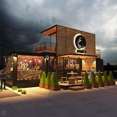 the exterior of a restaurant at night with people standing outside and dark clouds in the background