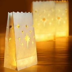 two paper bags with stars on them are sitting on a table next to each other