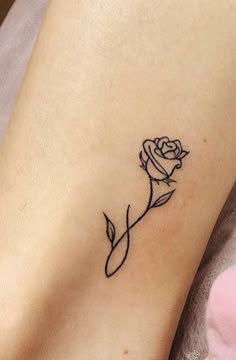 a small rose tattoo on the ankle