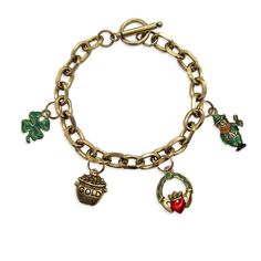 The perfect gift for St. Patrick's Day or to celebrate Irish heritage! Our NEW Toggle Charm Bracelet is comes in an antique gold finish and features 4 coordinating, hand-painted, theme-specific charms, including Leprechaun, Claddagh, 4 Leaf Clover Pot of Gold charms. Bracelet length is 7.0 inches and secures with toggle bar and clasp for easy, one-handed closure. Classic chain design is terrific on its own, layered with other bracelets, or with any of our handcrafted watches! Bracelet Features:  - Classic Toggle-Style Chain Bracelet  - Includes 4, Lead- and Cadmium-Free, American-Manufactured Charms  - Hand-Painted and Hand-Assembled by Our Team  - Antique Gold or Antique Silver Finish  - Bracelet Length: 7.0 inches  - Whimsical Gifts Logo Gift Box and Organza Gift Bag Included  - 1-Year L Pot Leaf Bracelet, Gift Logo, Whimsical Gifts, 4 Leaf Clover, Logo Gifts, Irish Heritage, Charms Bracelet, Gold Charms, Toggle Bracelet