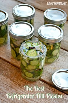 the best refrigerator dill pickles in a mason jar on a picnic table with text overlay that reads, the best refrigerator dill pickles