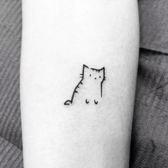 a small cat tattoo on the arm