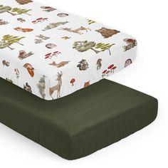 two baby crib mattresses with woodland animals on them, one is green and the other is white