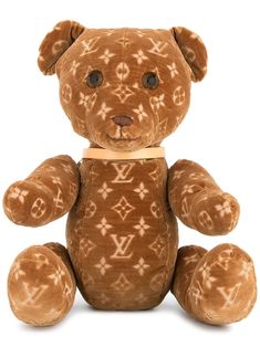 a brown teddy bear sitting up against a white background