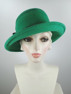 This pretty Kelly green medium brim hat is hand blocked over a vintage hat block and hand sewn. The asymmetrical brim rolls upward in the front and on the left side. Millinery wire is sewed inside of the brim edge to help the hat keep it's shape. The band is a gorgeous vintage patent leather with a matching bow. The top of the hat is hand embroidered in a swirl pattern in black cotton floss. An inner grosgrain headband helps avoid damage from makeup. Gorgeous in every way!+++++++++++++++++++++++ Adjustable Green Fedora Felt Hat, Green Hat Bands For Kentucky Derby, Wool Wide Brim Hat For Kentucky Derby, Wide Brim Wool Hat For Kentucky Derby, Adjustable Green Costume Hats With Short Brim, Adjustable Green Wide Brim Fedora, Green Adjustable Wide Brim Fedora, Adjustable Green Wide-brim Fedora, Adjustable Wide Brim Green Felt Hat