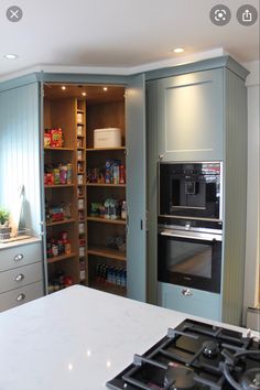 a kitchen with an oven, stove and cabinets in it's center island area