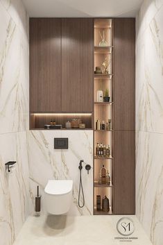 a bathroom with marble walls and flooring is shown in this image, there are shelves on either side of the toilet