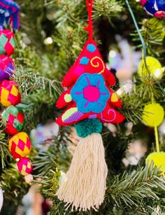 colorful ornaments hanging from a christmas tree