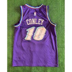 a purple jersey with the number forty on it sitting on top of a green carpet