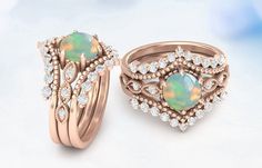 two wedding rings with opal and diamond accents on top of each other in pink gold