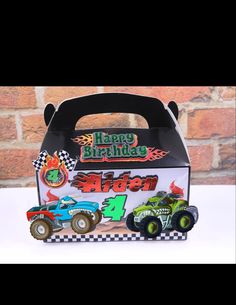 a birthday card box with two monster trucks on the front and one in the back