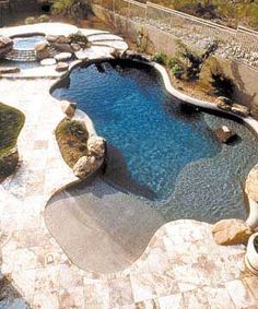 an image of a pool that is in the middle of someone's yard or patio