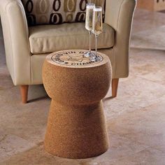 two glasses of champagne sitting on top of a table next to a chair and couch