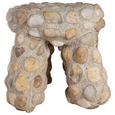 a stone stool made out of rocks on a white background